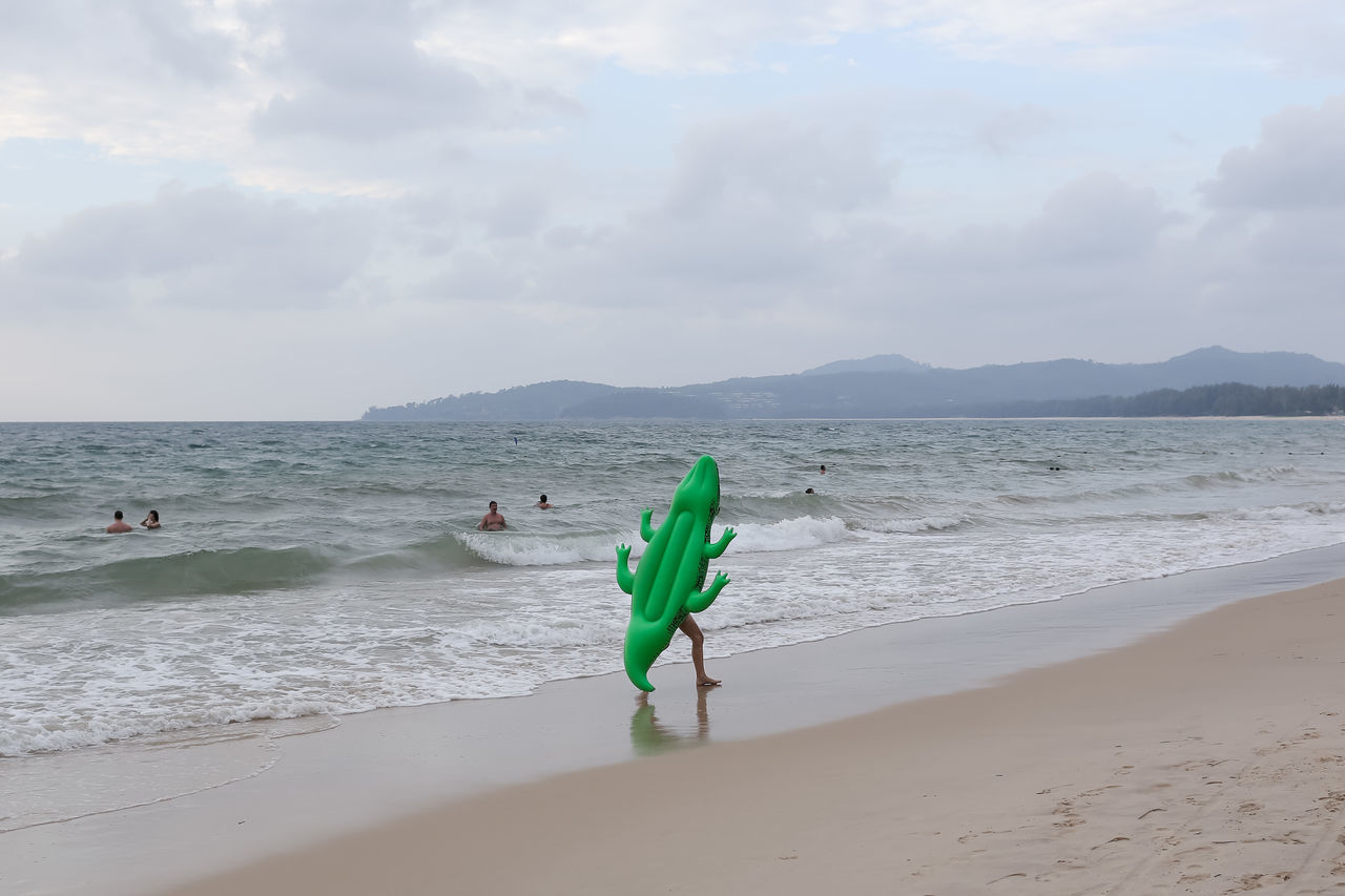 sea, water, sky, beach, beauty in nature, nature, horizon over water, scenics, green color, outdoors, real people, day, cloud - sky, tranquil scene, men, leisure activity