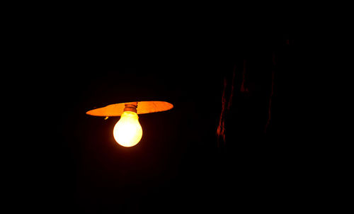 Low angle view of illuminated lamp post at night