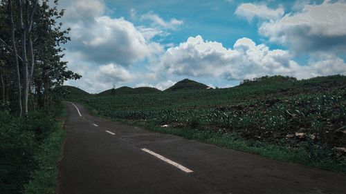 Empty road along countryside landscape