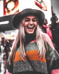 Portrait of smiling young woman wearing hat