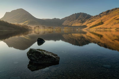 Scenic view of lake and mountains against sky