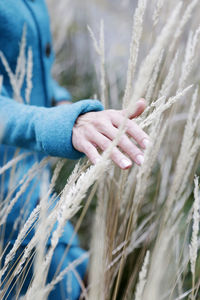 Midsection of woman touching plants