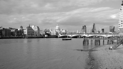 St paul cathedral by bridge over thames river in city