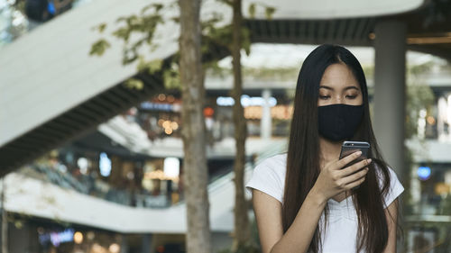 Portrait of young woman using mobile phone