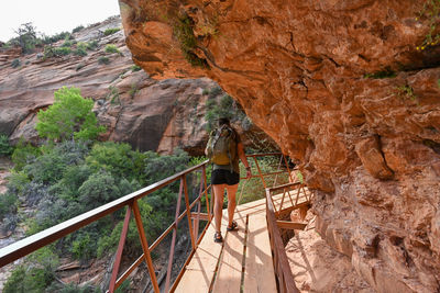 Rear view of woman walking on mountain