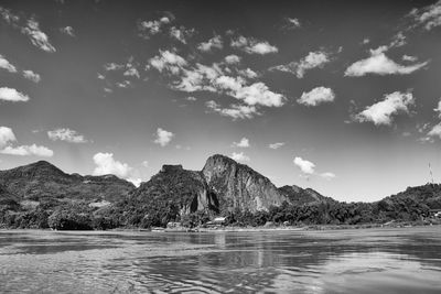 Scenic view of sea and mountains against sky