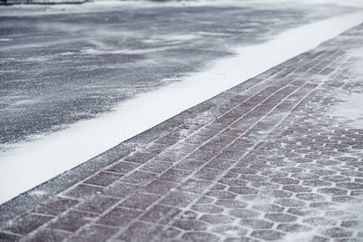 Close-up of snow on footpath