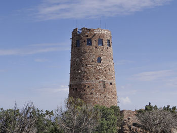A tower in the grand canyon national park against a cloudy sky on a beautiful summer morning