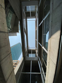 Directly below shot of staircase amidst buildings against sky