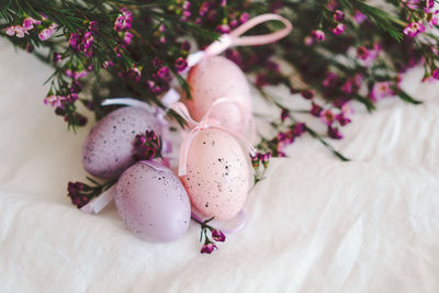 Easter eggs with flowers on white linen fabric.