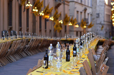 Illuminated table and chairs at sidewalk cafe