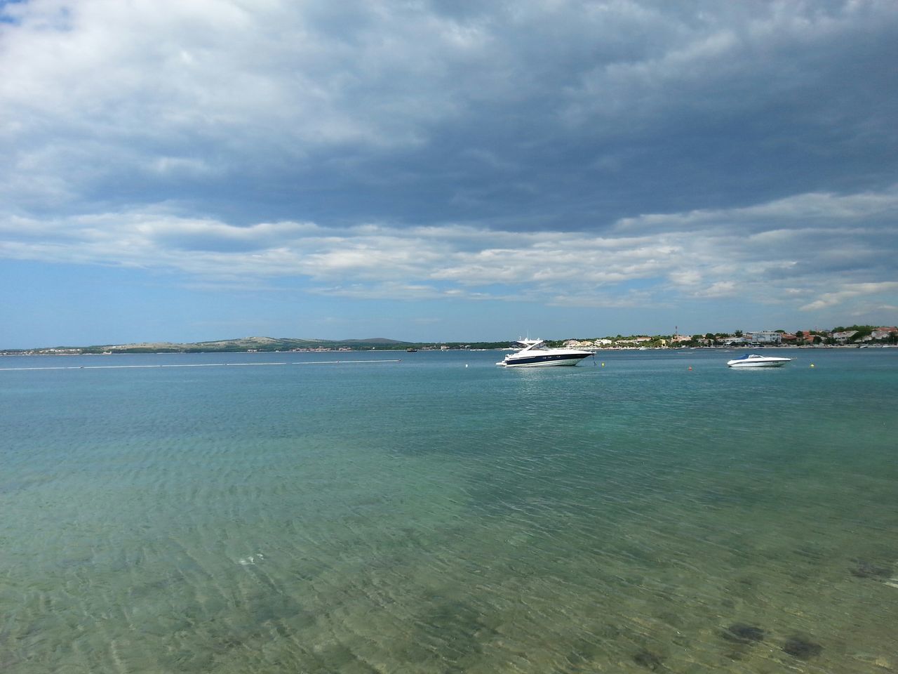 water, sea, nautical vessel, sky, transportation, cloud - sky, boat, mode of transport, cloudy, waterfront, tranquil scene, tranquility, scenics, cloud, beauty in nature, nature, moored, horizon over water, rippled, day