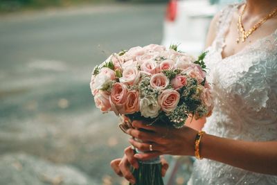 Close-up of woman holding rose bouquet