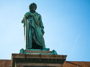 Low angle view of statue against blue sky