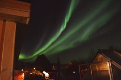 Low angle view of illuminated building against sky at night