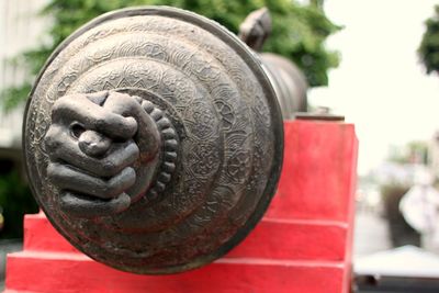 Close-up of metallic object on footpath