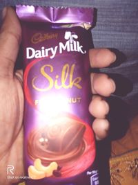 Close-up of person hand holding illuminated text