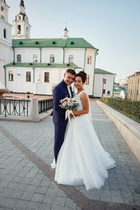 Full length of happy woman with umbrella