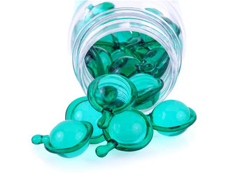 Close-up of precious gems in glass jar on white background