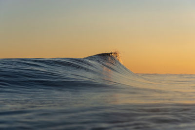 Scenic view of sea against orange sky