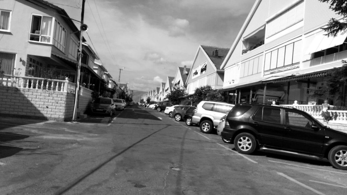 building exterior, architecture, built structure, building, city, low angle view, residential building, sky, street, residential structure, power line, transportation, the way forward, street light, house, outdoors, cable, day, sunlight, no people