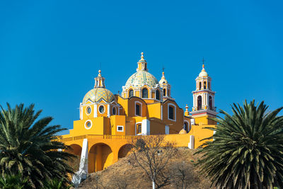 Our lady of remedies church against clear blue sky with palm trees in backgrounds