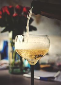 Close-up of wine poured into wineglass