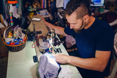 Man working on sewing machine