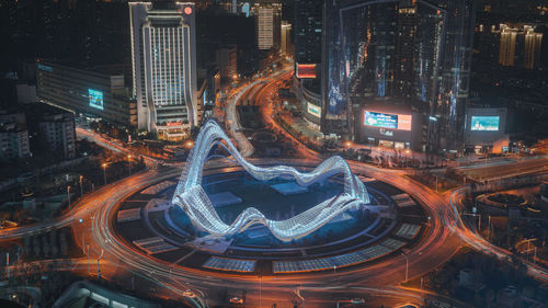 High angle view of illuminated city buildings at night