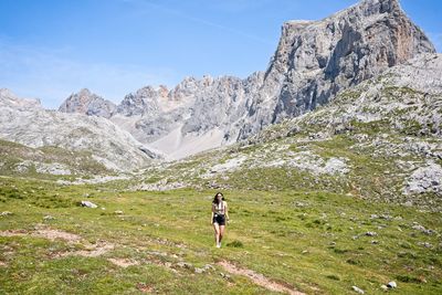 A young woman goes hiking in the mountains