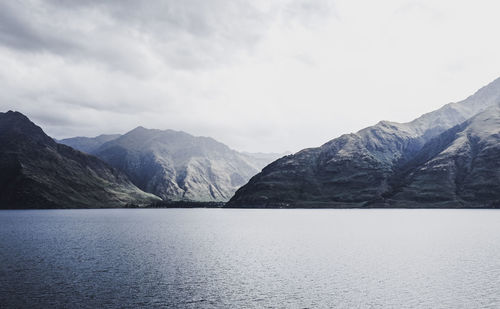 Scenic view of lake and mountains against sky