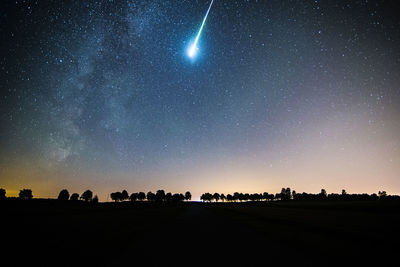 Low angle view of meteor shower and star field in sky
