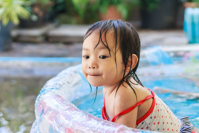 Close-up of girl sitting in wading pool