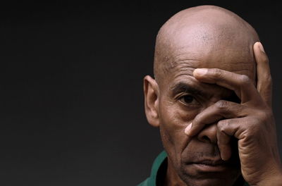 Close-up of man against black background