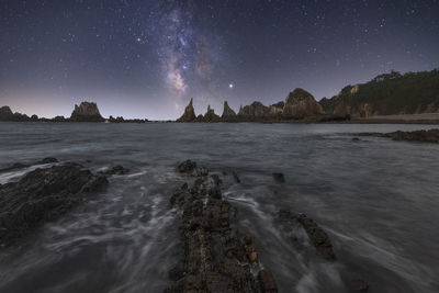 Scenic view of sea against sky at night