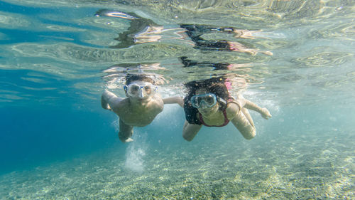 Couple swimming undersea