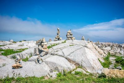 Statue on rock against sky