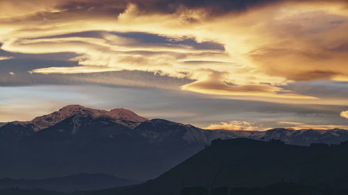 Scenic view of mountains against dramatic sky