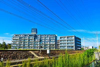 Buildings against clear blue sky in city