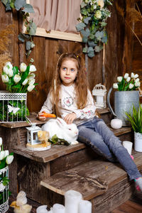 Portrait of smiling young woman sitting on table