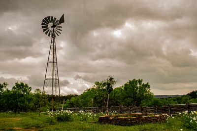 Old windmill water trough under dramatic sky