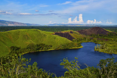 Scenic view of green landscape against sky