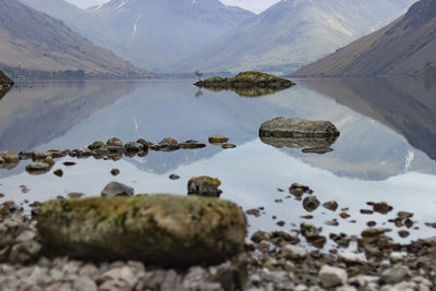 Scenic view of lake and rocks against sky