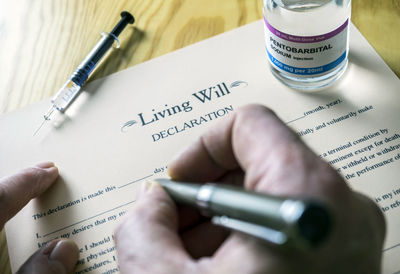 Midsection of person reading book on table