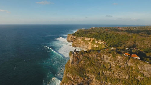 Aerial view of sea rocky coast with surf the waves, bali, indonesia, pura uluwatu cliff. 