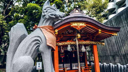 Low angle view of statue against temple