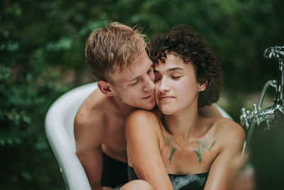 Portrait of young couple kissing outdoors