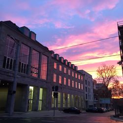 Buildings in city at sunset