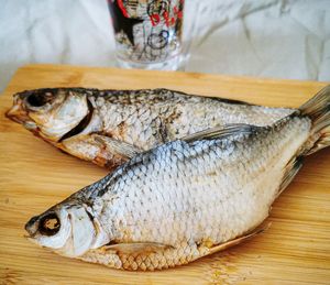 High angle view of fish on cutting board