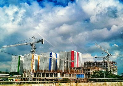 Industrial building against cloudy sky